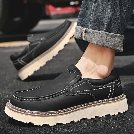 Fashionable men's loafers with white soles worn with denim jeans.