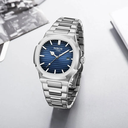 Stainless steel men's quartz watch with blue dial and date display on a stylish strap